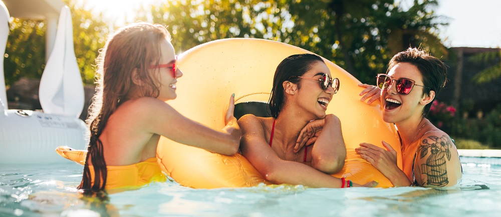 Girls Enjoying A Day In Swimming Pool