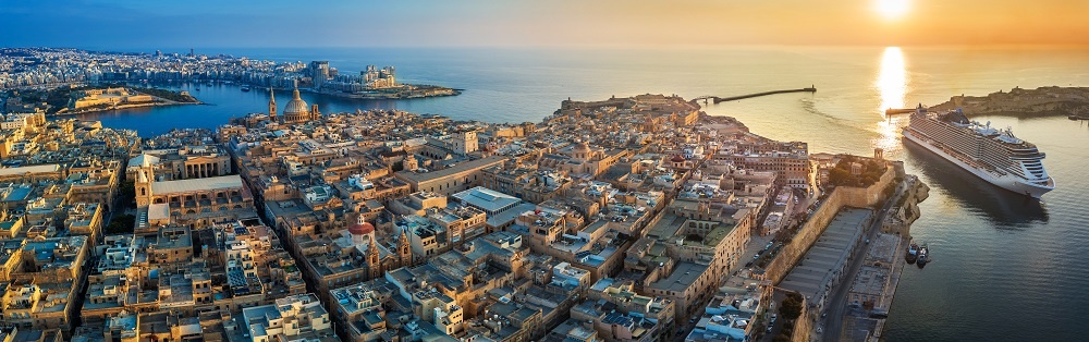 Valletta, Malta Aerial Panoramic View Of Valletta With Mount Carmel Church, St.paul's And St.john's Cathedral, Manoel Island, Fort Manoel, Sliema And Cruise Ship Entering Grand Harbor At Sunrise