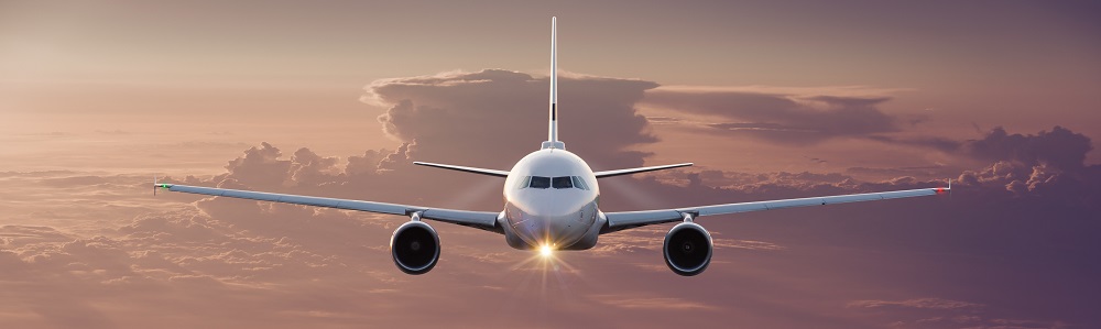 Commercial Airplane Flying Above Clouds.