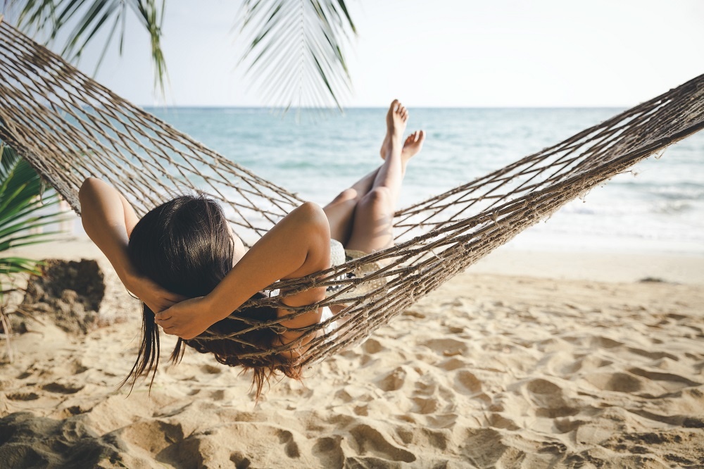 Happy Woman Relaxing In Hammock