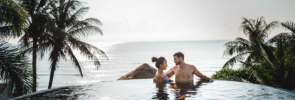 Couple Relaxing In Swimming Pool