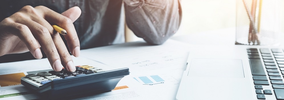 Close Up A Man Working About Financial With Calculator At His Office To Calculate Expenses, Accountigng Concept