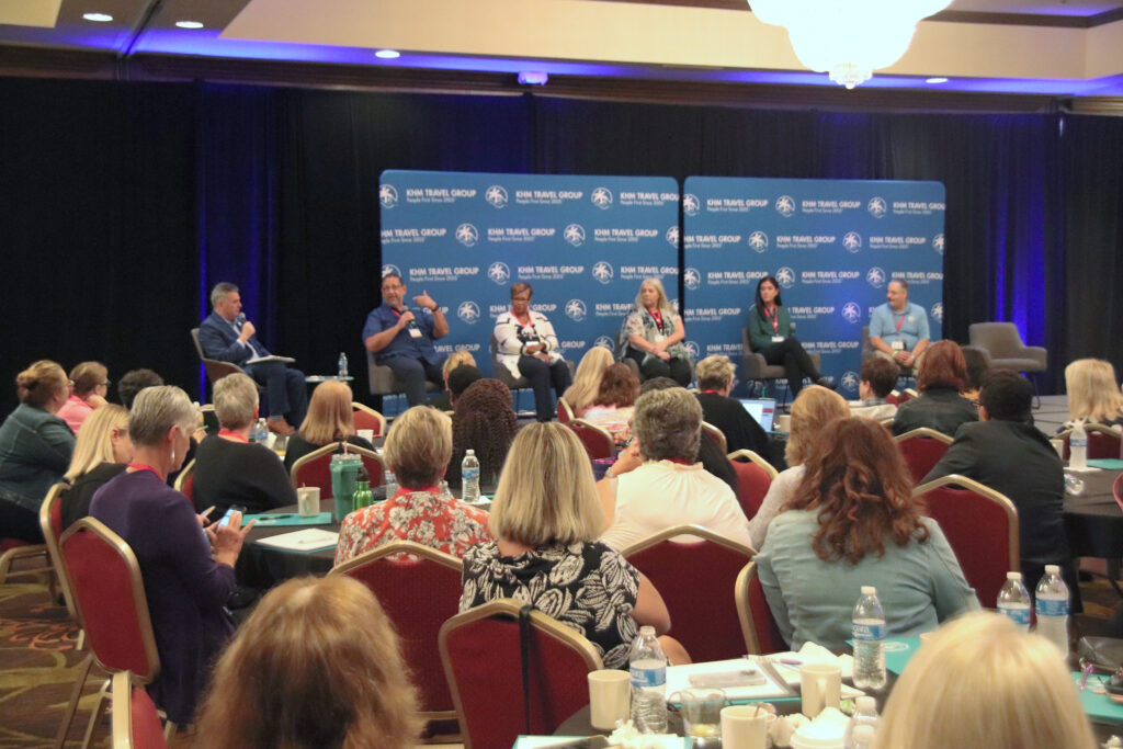 Group of agents listening to panel on stage