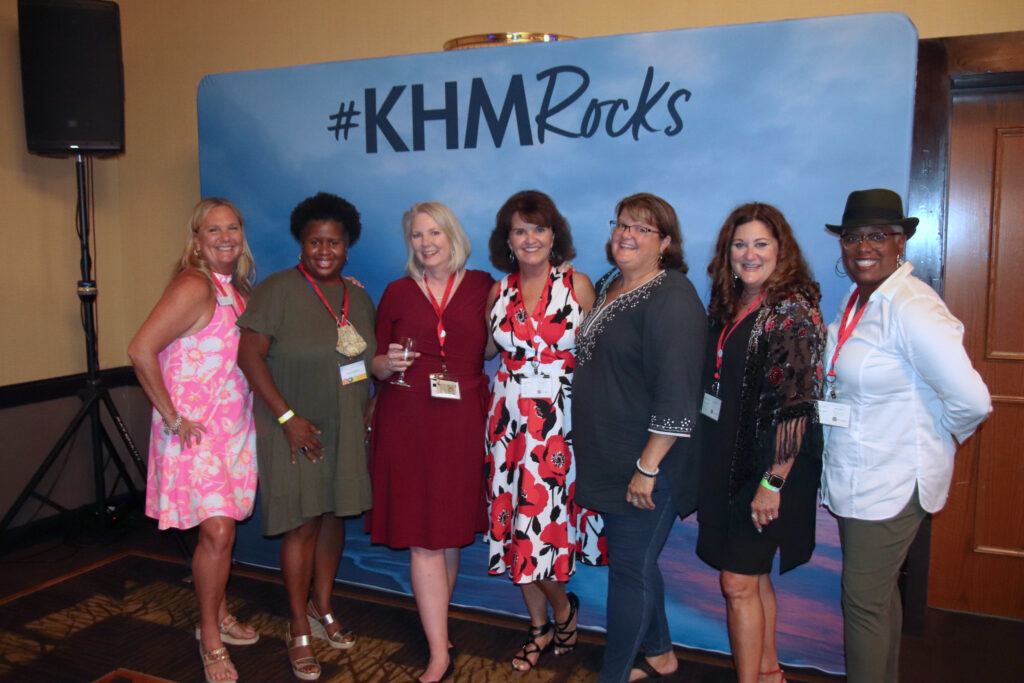 Agents posing in front of KHM Rocks backdrop