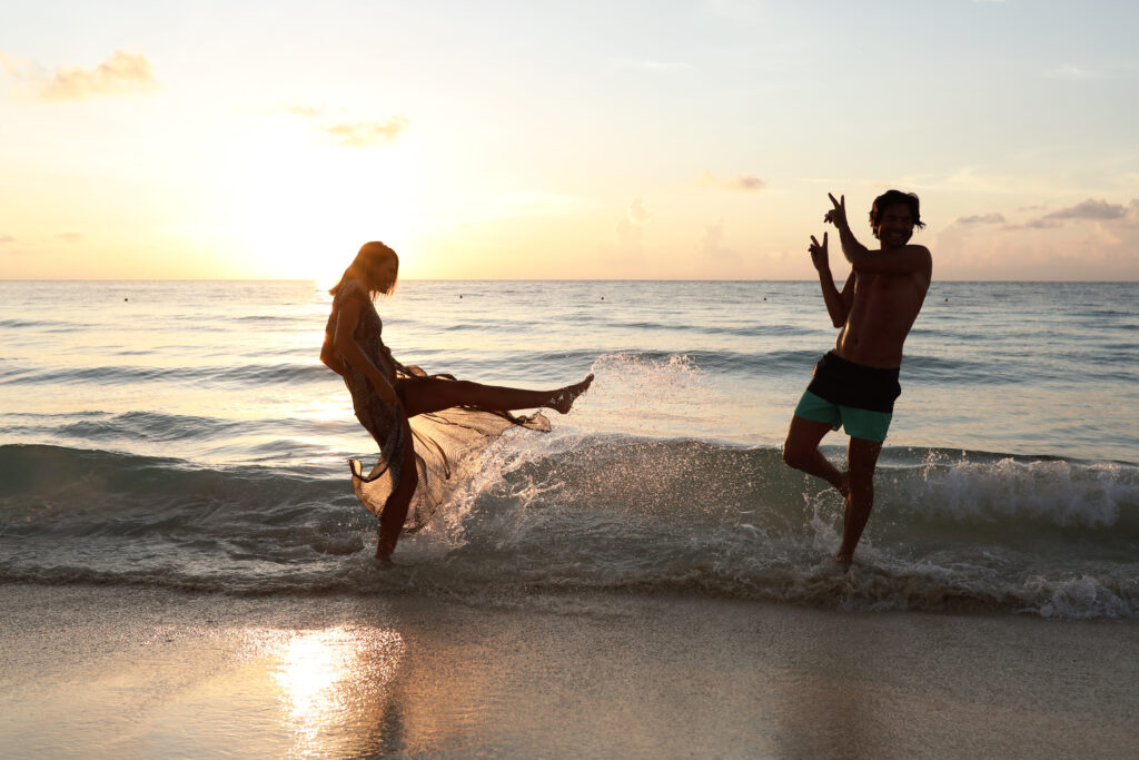 Couple playing in waves on Iberostar beach