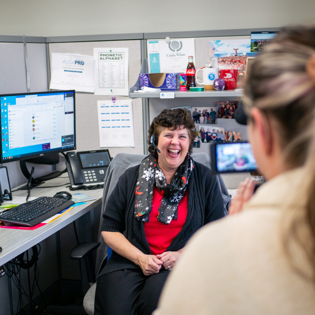 Agent Support team member laughing at the camera