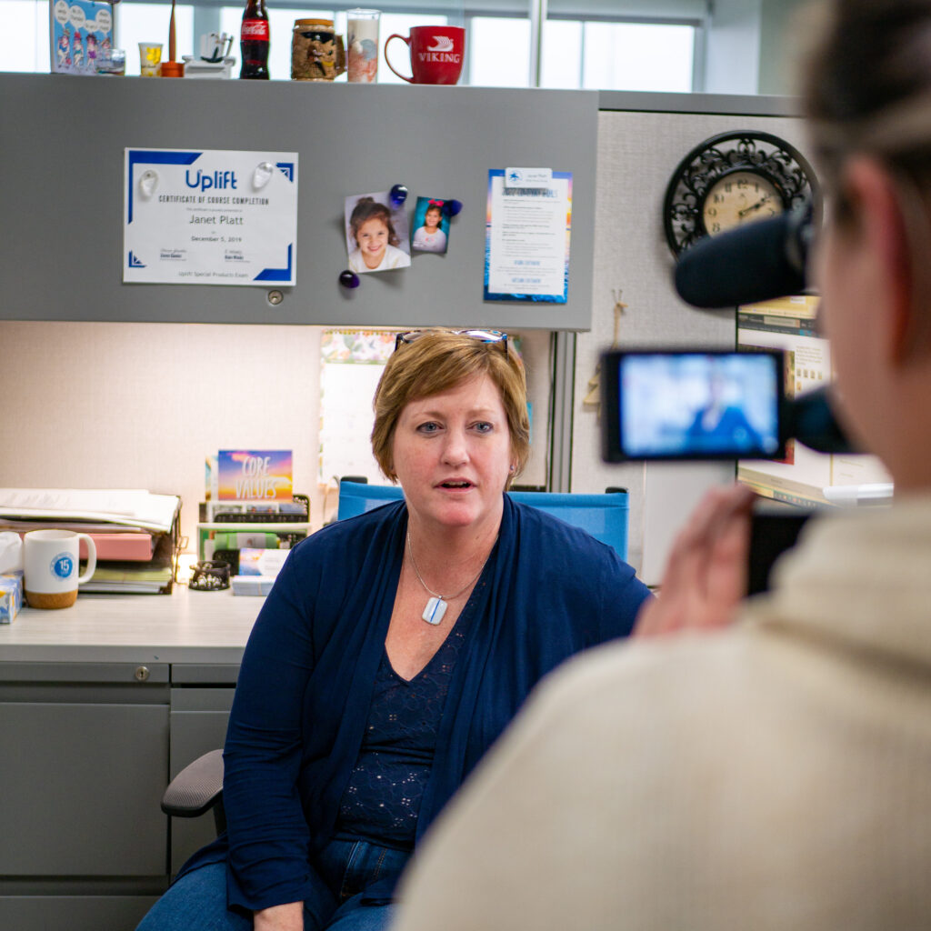 Compliance team member filming our holiday video at her desk