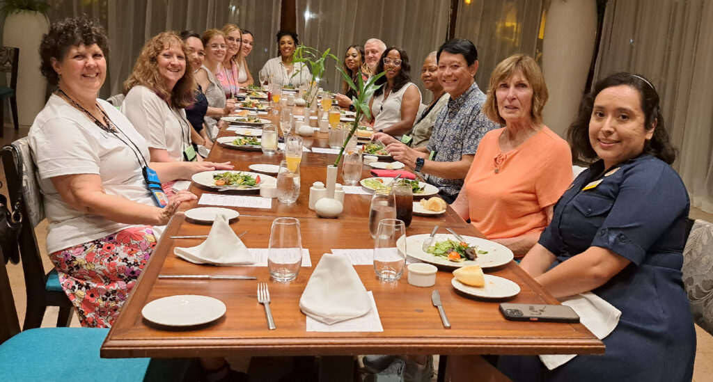 Agents with salads on their plates at dinner during Karisma FAM