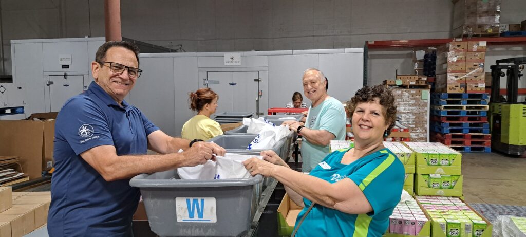 Giving back at Feeding Medina County by packing food for families